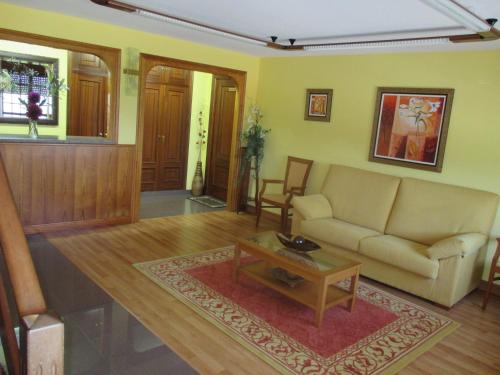 a living room with a couch and a coffee table at Hotel Chola in Dorna