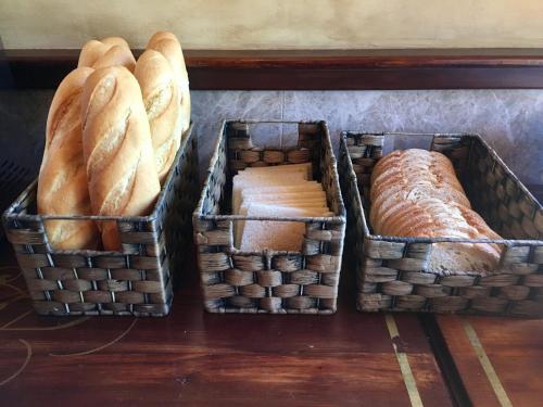 three baskets filled with bread on top of a table at Hostal Juan Carlos in Carboneras