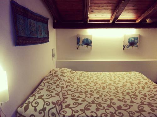 a bedroom with a bed and two lights on the wall at A Due Passi Da Tutto in Castellammare del Golfo