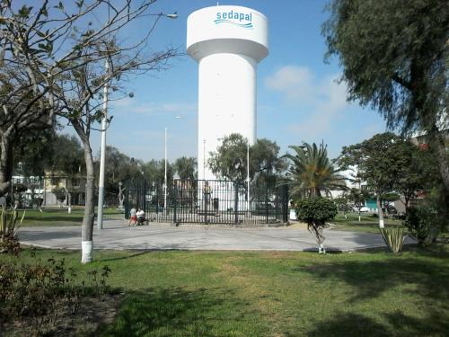 a water tower with a sign on it in a park at Royal Sweet Dreams Airport B&B in Lima