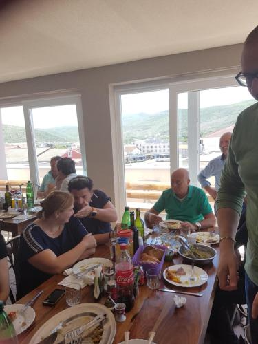 a group of people sitting at a table eating food at Hotel Quo Vadis in Međugorje