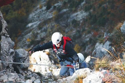 two people walking on a mountain with a rope at Chalet Kujta in Peje