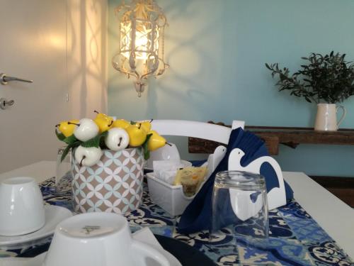 a table with a table cloth with eggs in a vase at Casa del Corso in Taviano