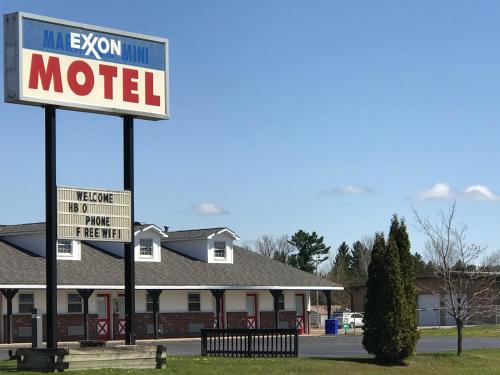 a motel sign in front of a house at Exxon Quik Stop & Motel in Wausaukee