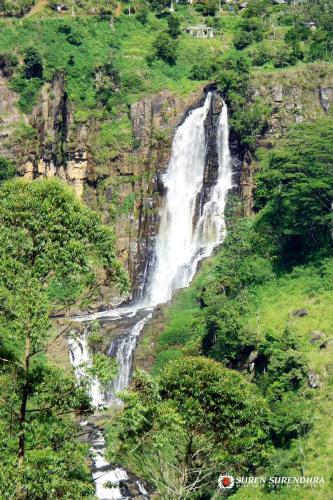 a waterfall on the side of a mountain at Tea Hills Bungalow in Hatton
