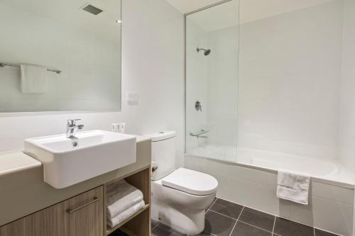 a bathroom with a sink and a toilet and a shower at Quest Chatswood in Sydney