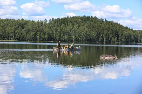 a group of people in a canoe on a lake at Trollebo Säteri in Vetlanda