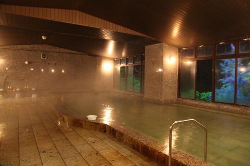a large pool of water in a building at Hotel New Ohruri in Nikko