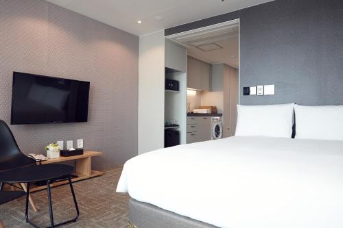 a hotel room with a bed and a television at Royal Square Hotel Seoul in Seoul