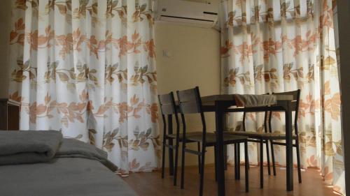 a dining room with a table and two chairs at Villa Konzuli in Bitola