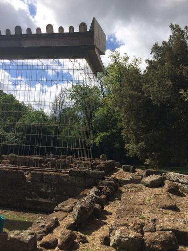 a view of a fence and some rocks and trees at Hotel Tempio di Apollo in Olgiata