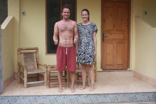 a man and a woman standing in front of a house at Roby Homestay in Kuta Lombok