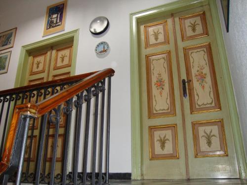 a hallway with two doors with paintings on the wall at Ca' de Capun in Manarola