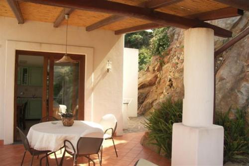 a patio with a table and chairs in a house at Villa Hermes Case Vacanza in Lipari