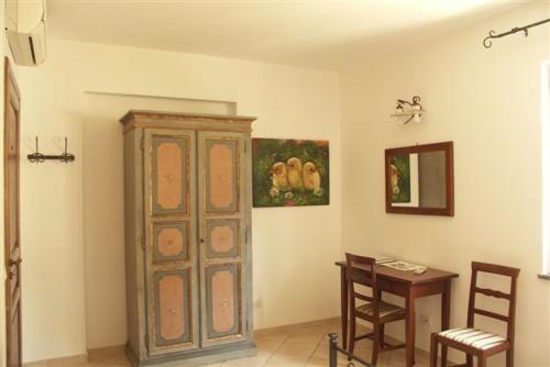 a room with a wooden cabinet and a table and a mirror at Villa Hermes Case Vacanza in Lipari