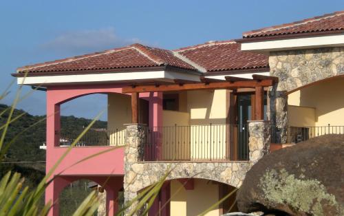 a house with a balcony and a roof at Hotel Sa Cheya Relais & Spa in Alghero
