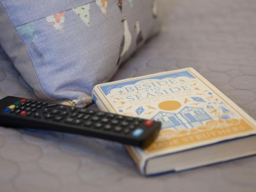 a remote control sitting on top of a book at The Studio @ 93 Bernard Rd in Brighton & Hove