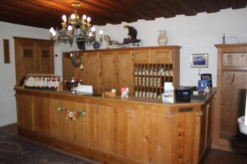 a bar in a room with wood paneling at Posthotel Arnold in Gunzenhausen