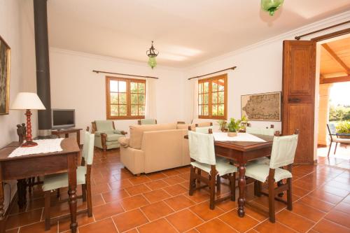 a living room with a table and a couch at Can Moscari in Inca