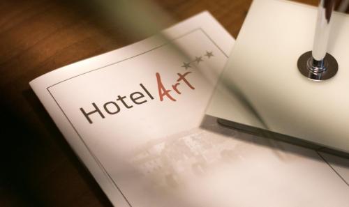 a notebook with the words hotel act written on it at Hotel Art in Písek