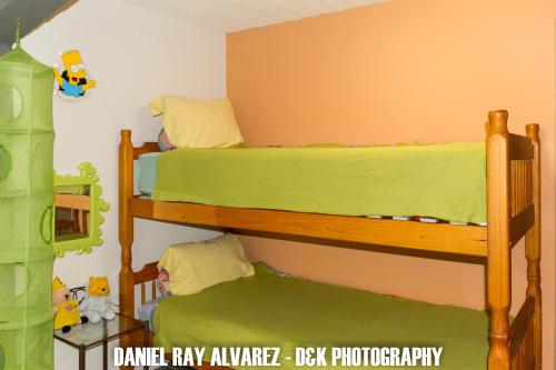 a bedroom with two bunk beds with green sheets at B&B Aalsters genot in Aalst
