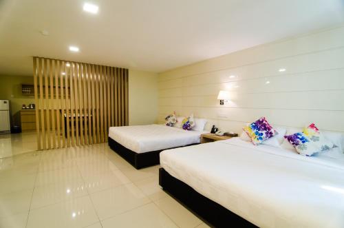 Ένα ή περισσότερα κρεβάτια σε δωμάτιο στο Mornington Hotel Sitiawan