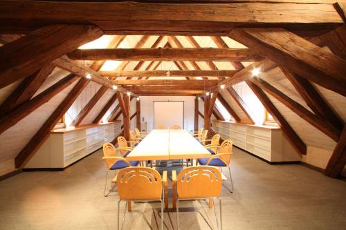 a conference room with a table and chairs in a building at Hotel-Landgasthof Schuster in Greding