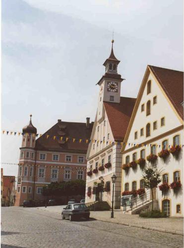 a large building with a clock tower on top of it at Hotel-Landgasthof Schuster in Greding