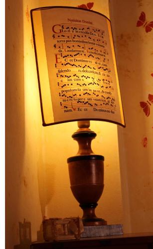 a lamp sitting on a table with a paper on it at Antico Borgo Casalappi in Campiglia Marittima