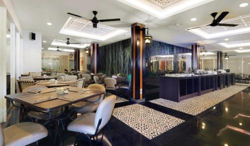 a dining room with tables and chairs in a restaurant at Pranaya Boutique Hotel in Serpong
