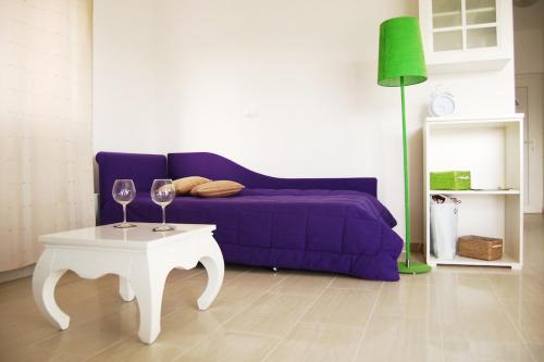 a living room with a purple couch and a table at Good Spirit in Trogir