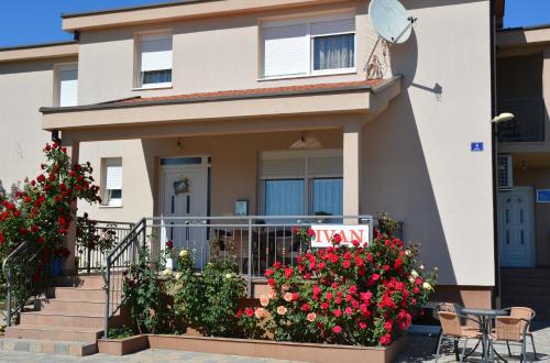 a house with some flowers in front of it at Pansion Ivan in Međugorje