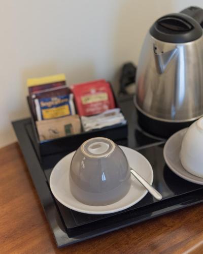 a tea pot sitting on a plate on a tray at Relais Dei Mandorli in Bergamo