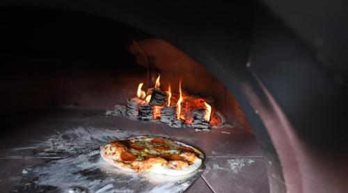 a pizza is cooking in a brick oven at The Royal Heysham in Heysham