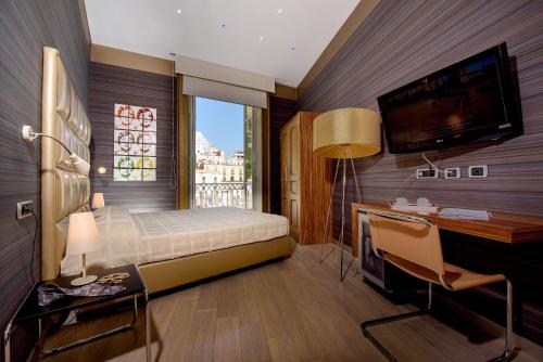 Säng eller sängar i ett rum på Palazzo Ferraioli - Hotel & Wellness