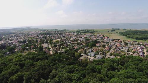 an aerial view of a town in the middle of a forest at Waldschloss Parow in Ostseebad Koserow