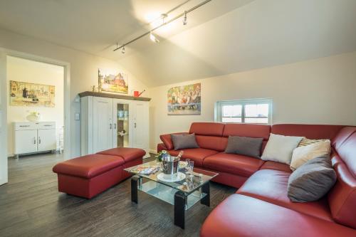 a living room with a red couch and a table at Villa Scandic Apartments in Rust