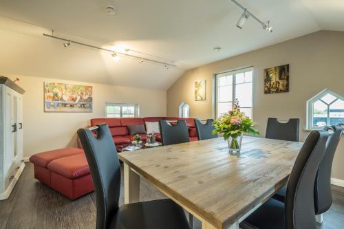 a dining room with a table and chairs and a couch at Villa Scandic Apartments in Rust