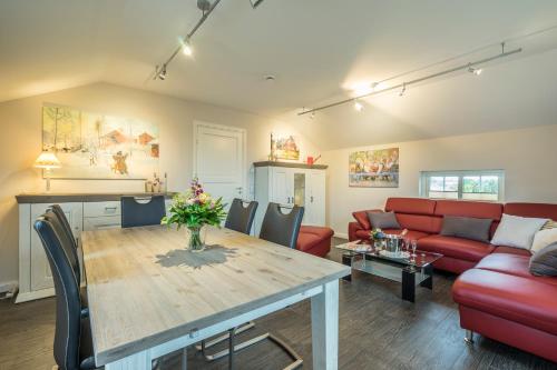 a living room with a table and a red couch at Villa Scandic Apartments in Rust
