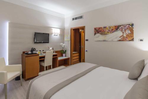 a bedroom with a bed and a desk and a television at Hotel La Giocca in Rome