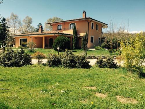 a house in a field with a yard at Bed & Breakfast Le Piagge in Scurcola Marsicana