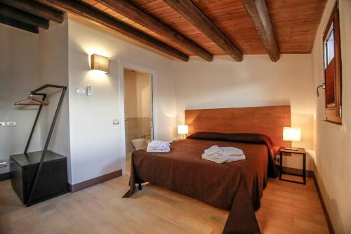 מיטה או מיטות בחדר ב-Agriturismo Le Chiuse di Guadagna
