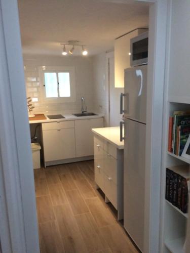 a kitchen with white cabinets and a refrigerator at Casa Aldea de la Gitana in Estepona