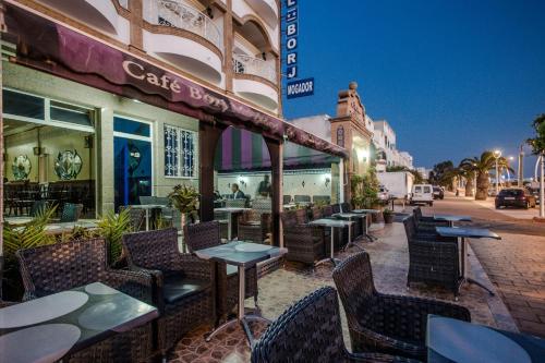 a restaurant with tables and chairs on a street at Hotel Borj Mogador in Essaouira