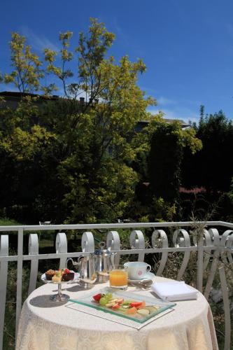 a white table with food on top of a balcony at Hotel Abbazia in Grado