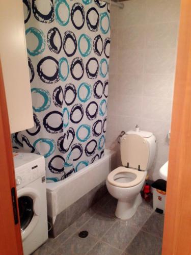 a bathroom with a toilet and a shower curtain at Sakis in Siviri