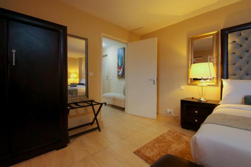 a hotel room with a bed and a mirror at Best Western Plus Accra Beach Hotel in Teshi