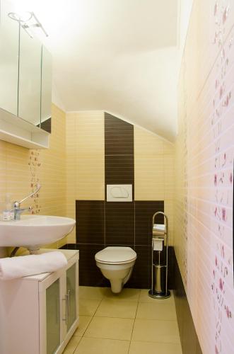 a bathroom with a toilet and a sink at Harmónia Apartmanház in Eger
