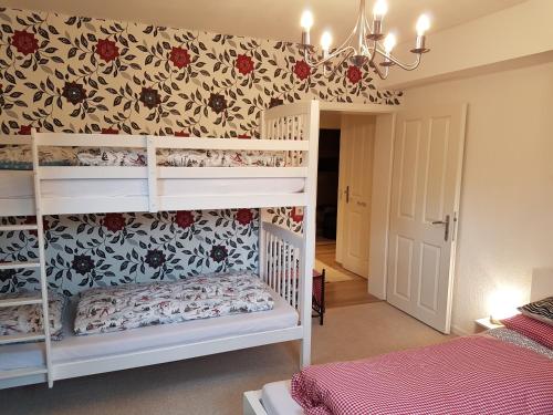 a bedroom with two bunk beds in a room at Haus Valder in Niedernsill