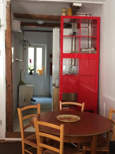 a dining room with a red cabinet and a table at Zum grünen Lindenbaum Z5C in Konstanz